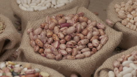 Dry-Borlotti-beans-falling-on-jute-bowl-at-slow-motion