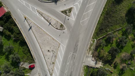 A-topdown-timelapse-of-a-road-intersection-with-cars-passing-by
