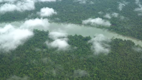 Flying-over-river,-jungle-and-clouds,-Gulf-Province,-Papua-New-Guinea