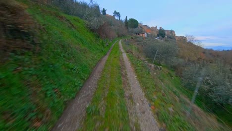 Narrow-dirt-road-tracks-along-a-hill-in-the-countryside-in-Italy