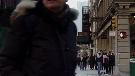 People-walking-on-crossroad-in-Soho,-New-York