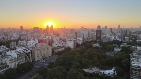 Dolly-out-flying-over-Recoleta-neighborhood-squares-and-buildings-at-golden-hour,-Buenos-Aires