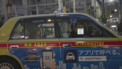 Passenger-Wearing-Facemask-In-A-Taxi-Stuck-In-Traffic-During-The-Pandemic-In-Tokyo,-Japan