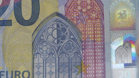 Macro-shot-of-European-twenty-euro-bank-notes-with-hologram-safety-feature
