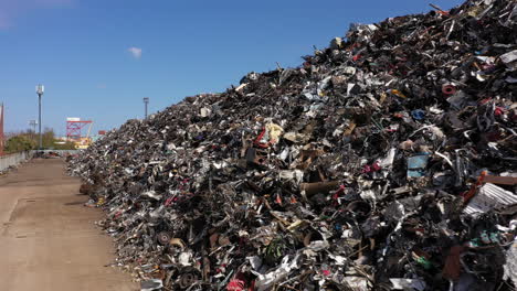 Footage-alongside-a-large-pile-of-scrap-metal-waiting-to-be-loaded-onto-a-ship-for-recycling