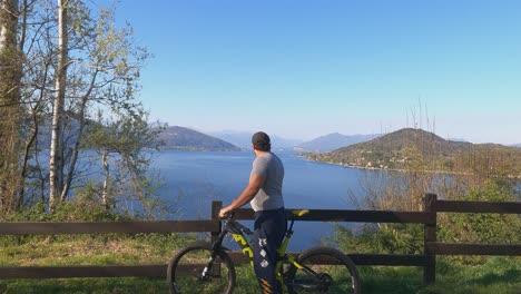 First-person-view-toward-biker-looking-at-panorama-over-Maggiore-lake