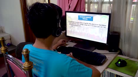 Young-boy-studies-at-home,-distance-online-education-due-to-pandemic-outbreak