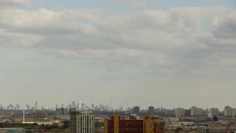 Clouds-Moving-In-The-Sky-Over-City-Buildings-And-Toronto-Skyline-In-The-Distance-In-Canada