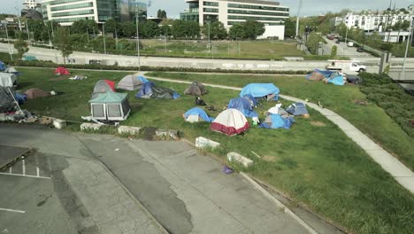 A-small-homeless-encampment-located-in-downtown-Seattle-along-the-freeway,-aerial-orbit