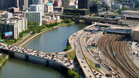 Aerial-view-of-Interstate-676-highway,-bridge-over-the-Schuylkill-River,-Railways-and-30th-Street-Station