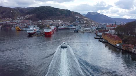 Following-close-behind-the-stern-of-Norled-Express-boat-approaching-Bergen-Harbour-in-Vestland-Norway