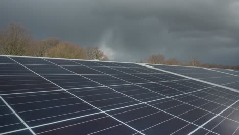 Clouds-time-lapse-over-solar-farm-panels,-renewable-sustainable-energy