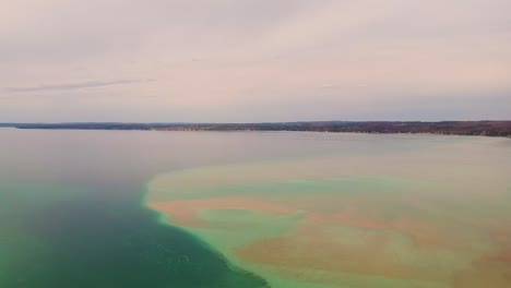 Drone-shot-of-Torch-Lake,-Michigan-on-a-cloudy-day