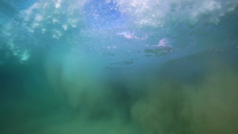 Underwater-POV-of-a-wave's-peak-and-trough-in-slow-motion