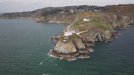 Baily-Lighthouse-At-Howth-Head,-Dublin-Bay-Ireland---aerial-drone-shot