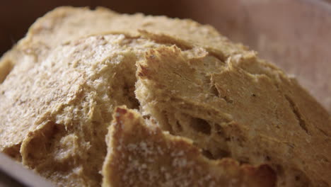 BAKING---Sourdough-bread-fresh-from-the-oven,-slow-motion-close-up-pan-left
