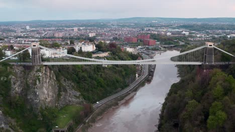Dolly-back-drone-shot-of-the-clifton-suspension-bridge-with-central-Bristol-in-the-background