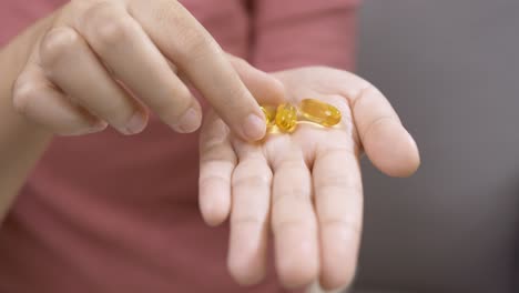 Young-woman-with-medicine-on-her-palm-for-use
