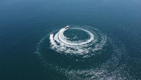 Caribbean-aerial:-Tourists-enjoy-bring-towed-on-raft-behind-motorboat