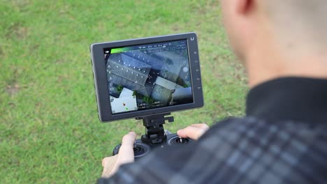 HD-Footage-of-Pilot-Using-DJI-Crystal-Sky-LCD-Monitor-in-Action-View-Over-the-Shoulder-of-a-Person-Flying-the-DJI-Inspire-2