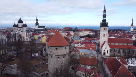 Aerial-descending-shot-of-Tallinn-old-town-with-churches-and-defensive-wall