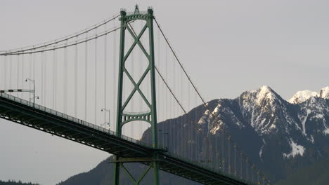 Famous-Lions-Gate-Bridge-Of-Vancouver-With-Snow-Packed-Mountains-On-Background-In-BC,-Canada