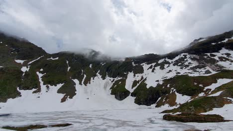 transfagarasan-Balea-lake-frozen,-Mountain-peak,-Clouds,-Nature-of-Romania