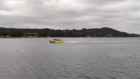 Ambulance-express-boat-Rygervakt-sailing-high-speed-through-Norwegian-fjord-on-a-rescue-mission-on-overcast-day