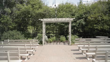 Gorgeous-outdoor-wedding-ceremony-venue-with-wooden-pews-and-a-pergola-on-the-forest-edge-of-the-property-at-the-Strathmere-Wedding-and-Event-Centre