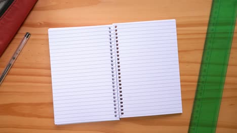 Male-Hands-Turning-Blank-Pages-Of-A-Notebook-On-The-Table