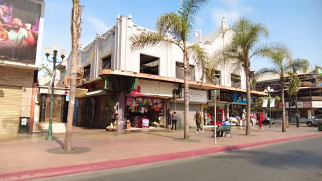 Shops-opening-up-on-Avenida-Revolucion,-Tijuana-Mexico