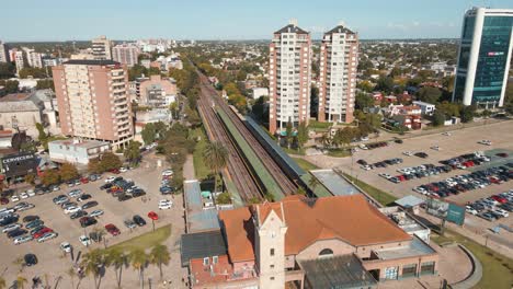 Aerial-view-flying-over-train-tracks-revealing-station-at-Tigre-city