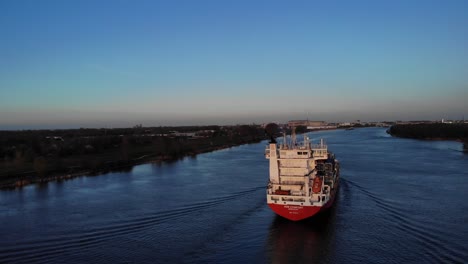 Rear-View-Of-Big-Cargo-Ship-Cruising-At-Oude-Maas-River-In-South-Holland,-Netherlands