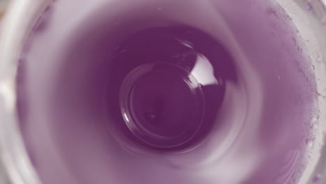 Making-Fresh-Purple-Juicy-Drink,-Top-View-on-Working-Blender,-4K