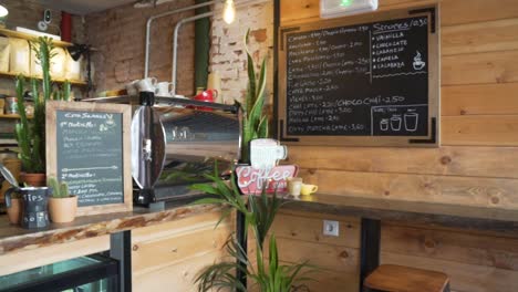 Interior-Of-A-Rustic-Coffee-Shop-With-Indoor-Plants-And-Chalkboard-Decoration