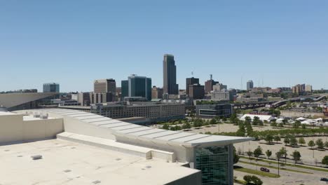 Drone-Flies-Over-CHI-Health-Center,-Reveals-Downtown-Omaha-Skyline-in-Background