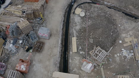 Pipeline-cables-laid-down-in-an-excavated-ditch-at-a-construction-site