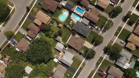 Aerial-birds-eye-shot-of-Suburban-Neighborhood-in-Welland-with-road-and-cars-during-sunny-day---Canada,Ontario