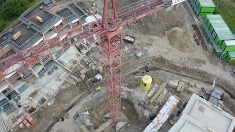 Red-construction-crane-between-new-apartments-being-built,aerial-view