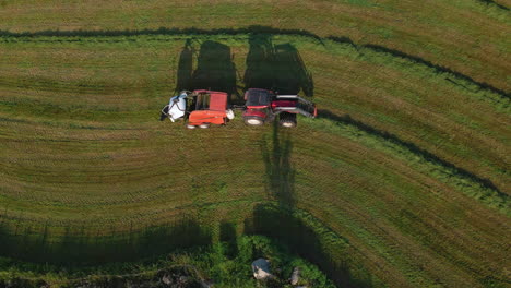 Top-View-Of-A-Baler-Pulled-By-Tractor-Making-Bale-On-A-Farm