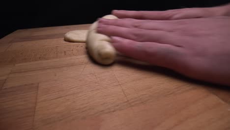 Pastry-chef-folding-piece-of-pastry-from-freshly-made-dough