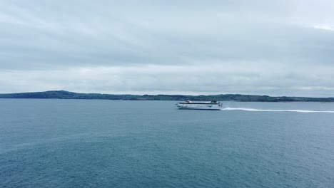 Irish-Ferries-passenger-transport-vessel-journey-across-Irish-sea-leaving-Holyhead-to-Dublin-aerial-following-left-view