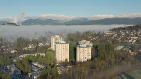 Luftaufnahme-Der-Sonne,-Die-über-Dem-Von-Nebel-Bedeckten-Pinienwald-In-Burnaby,-British-Columbia,-Kanada,-Scheint