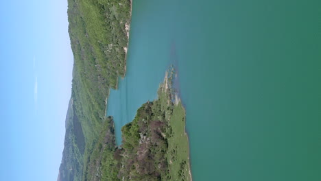 Scenic-flyover-above-lake-formed-by-Maneciu-Dam-in-Romania