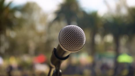 Close-up-of-Microphone-On-Stand-With-Blurred-Nature-In-Background