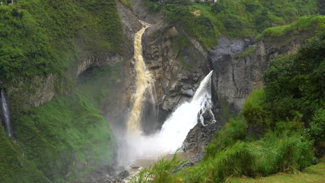 Huge-waterfall-crashing-down-the-green-amazon-rainforest-in-Ecuador,slow-motion-aerial-top-down