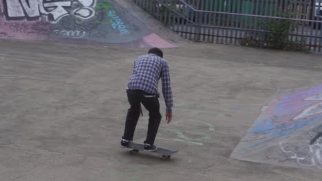 Slow-mo-of-skate-boarder-jumping-at-a-skate-park-in-Sheffield,-England