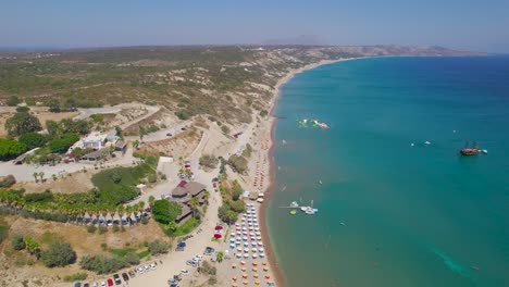 Aerial-view-down-length-of-Paradise-Beach,-Kos,-Greece