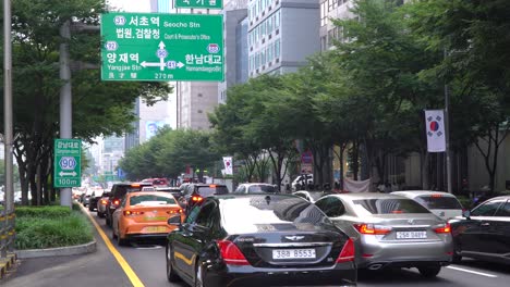 Afternoon-traffic-rush-hour-with-four-lanes-filled-with-cars-on-road,-Seoul