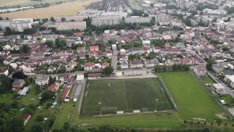 Top-view-of-an-empty-soccer-field-in-the-middle-of-a-housing-estate-and-houses